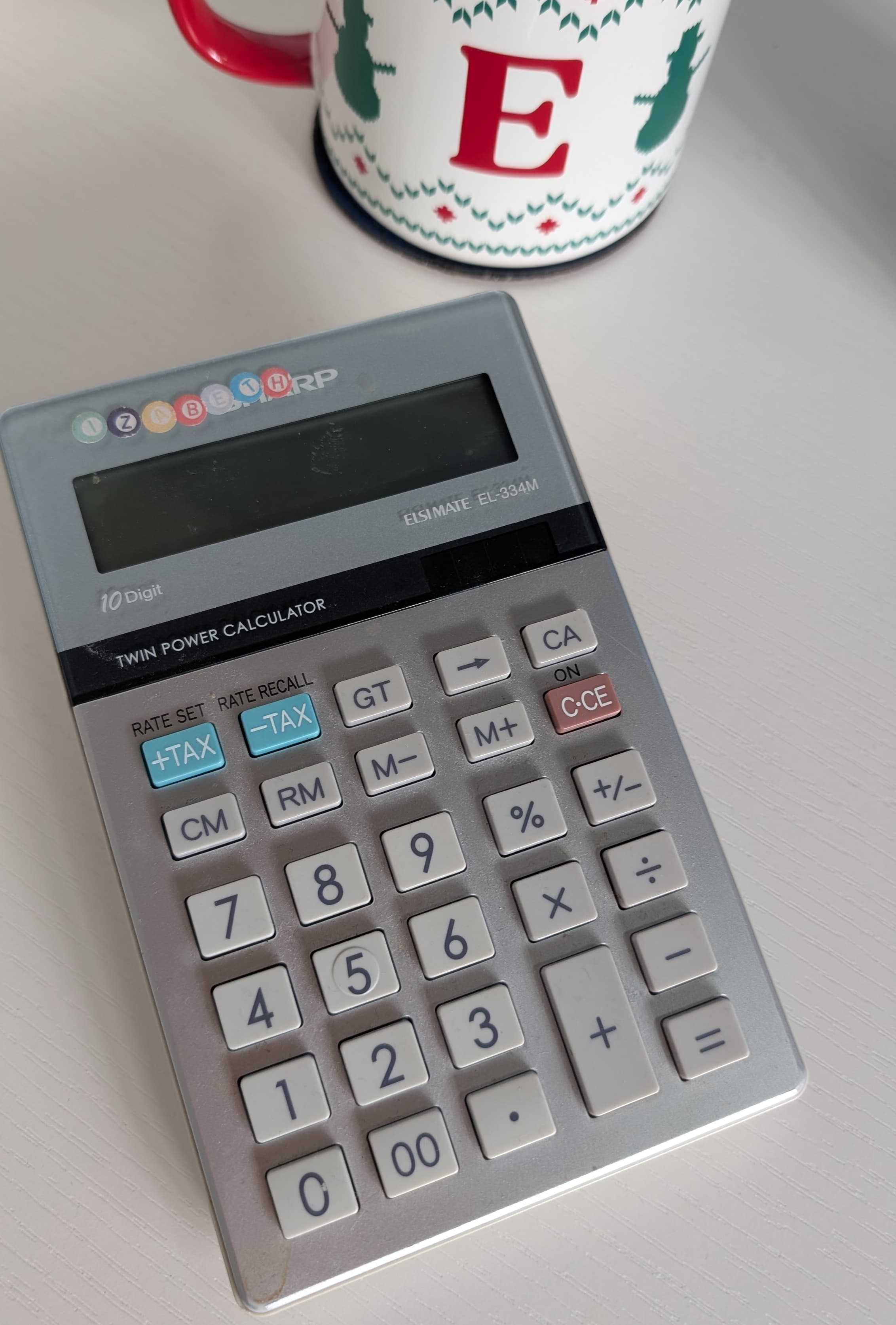 Elizabeth's calculator and coffee mug on her desk