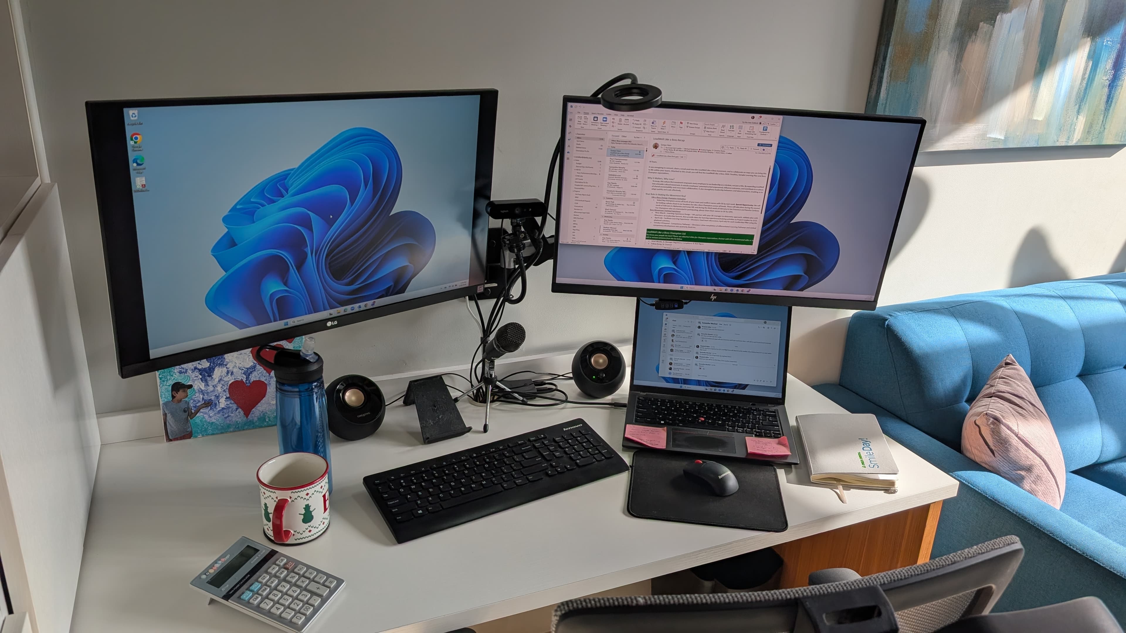 Elizabeth's home office desk setup with dual monitors, calculator, and water bottle